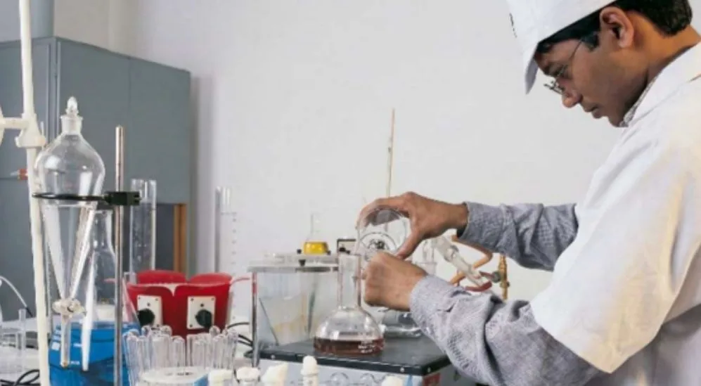 A scientist in a laboratory at Cybele, working with glassware